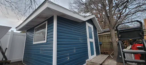 Sheds and exterior projects Blue shed exterior project with trim and siding details